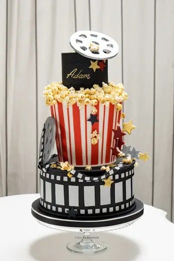 Film themed cake with handmade reel and popcorn.