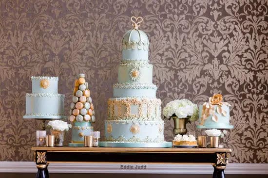 Duck egg blue dessert table including 5 tier wedding cake, 2 tier cake, 1 tier cake and maccarons.