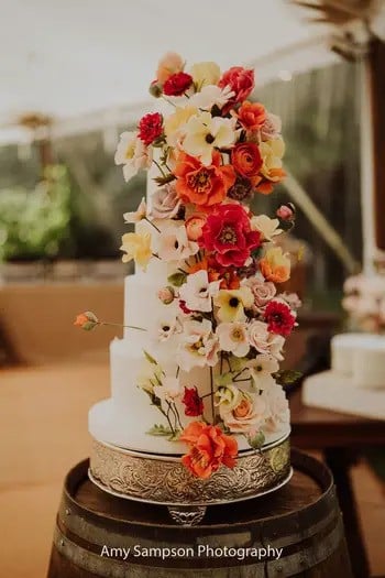 4 tier wedding cake decorated with handcrafted sugar flowers.